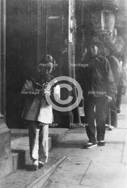 Young girl walking down a street, Chinatown, San Francisco, between 1896 and 1906. Creator: Arnold Genthe.