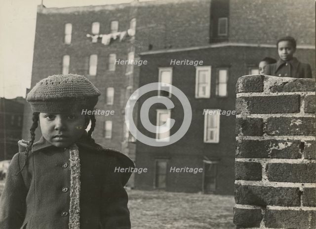 Young girl, with other children in background, in a vacant lot behind some tenement..., 1947 - 1951. Creator: Romulo Lachatanere.