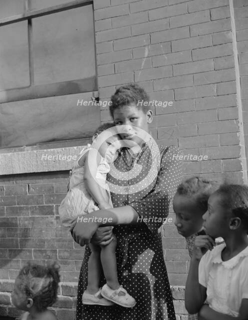 Young girl with her sister who live on Seaton Road, Washington, D.C., 1942. Creator: Gordon Parks.