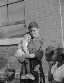 Young girl with her sister who live on Seaton Road, Washington, D.C., 1942. Creator: Gordon Parks