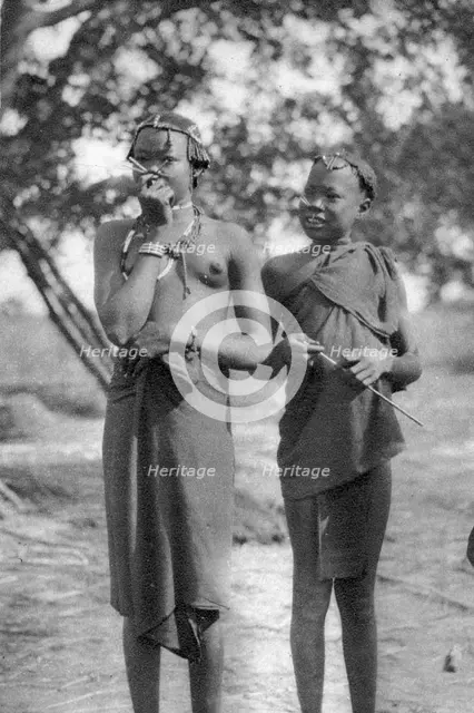 Young girls with sticks in their noses and lips, Terrakekka to Aweil, Sudan, 1925 (1927). Artist: Thomas A Glover
