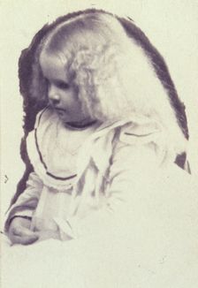 Young fair haired girl seated with hands in her lap, c1900. Creator: Estelle Huntington Huggins
