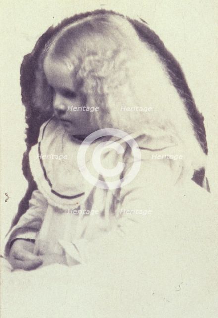 Young fair haired girl seated with hands in her lap, c1900. Creator: Estelle Huntington Huggins.