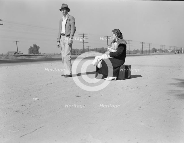 Young family, penniless, hitchhiking on U.S. Highway 99, California, 1936. Creator: Dorothea Lange.