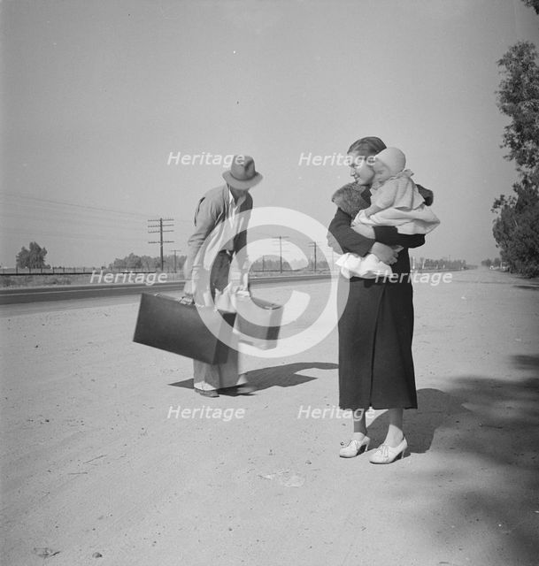 Young family, penniless, hitchhiking on U.S. Highway 99 in California, 1936. Creator: Dorothea Lange.
