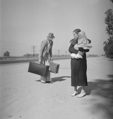Young family, penniless, hitchhiking on U.S. Highway 99 in California, 1936. Creator: Dorothea Lange