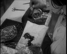 Young Female Civilian Embroidering a Piece of Fabric in an Arts Class, 1920. Creator: British Pathe Ltd