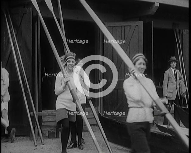 Young Female Civilians Wearing Sport Outfits Carrying Rowing Blades Arriving for a Rowing Class,1920 Creator: British Pathe Ltd.
