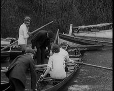 Young Female Civilians Wearing Sport Outfits Climbing Into a Rowing Boat, 1920. Creator: British Pathe Ltd
