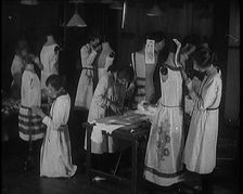 Young Female Civilians Sewing Dresses on Mannequins in an Arts Class, 1920. Creator: British Pathe Ltd
