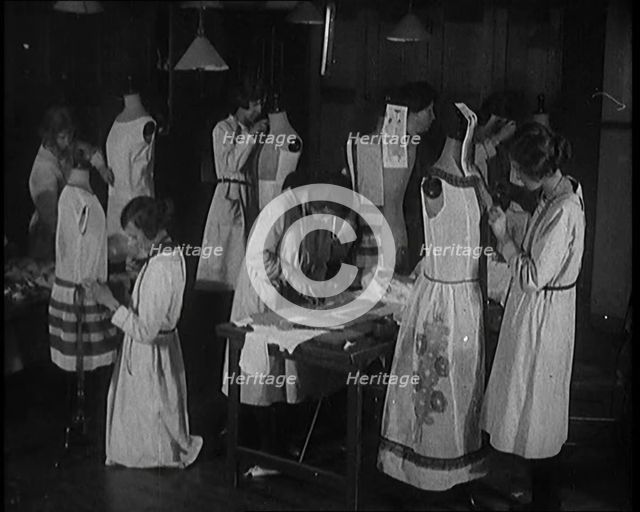 Young Female Civilians Sewing Dresses on Mannequins in an Arts Class, 1920. Creator: British Pathe Ltd.