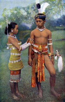 Young Iban or Sea Dayaks people in gala attire, Borneo 1922. Artist: Dr Charles Hose