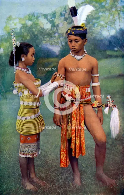'Young Iban or Sea Dayaks people in gala attire, Borneo', 1922. Artist: Dr Charles Hose