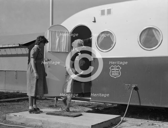 Young mother brings her child to the trailer clinic..., FSA, Merrill, Klamath County, Oregon, 1939. Creator: Dorothea Lange.