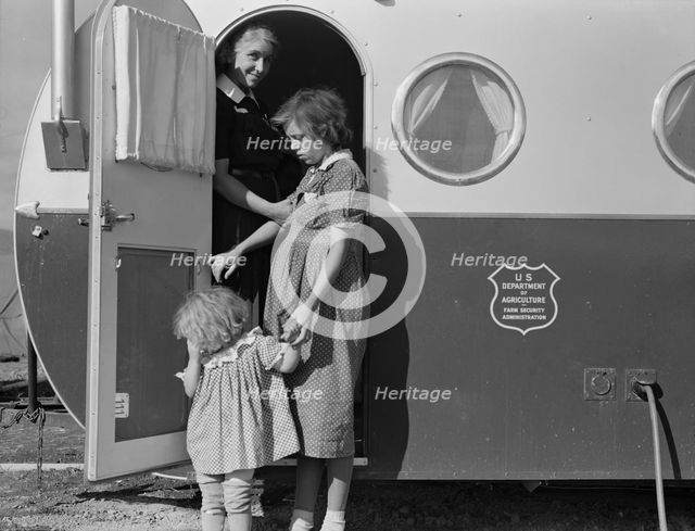Young mother brings her child to the trailer clinic..., FSA, Merrill, Klamath County, Oregon, 1939. Creator: Dorothea Lange.