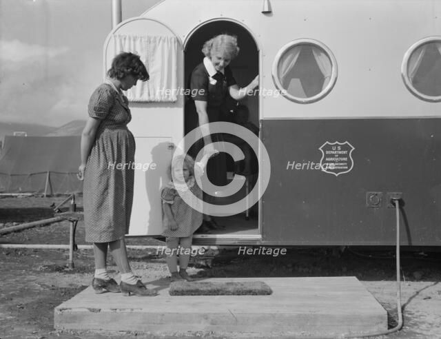Young mother brings her child to the trailer clinic..., FSA, Merrill, Klamath County, Oregon, 1939. Creator: Dorothea Lange.