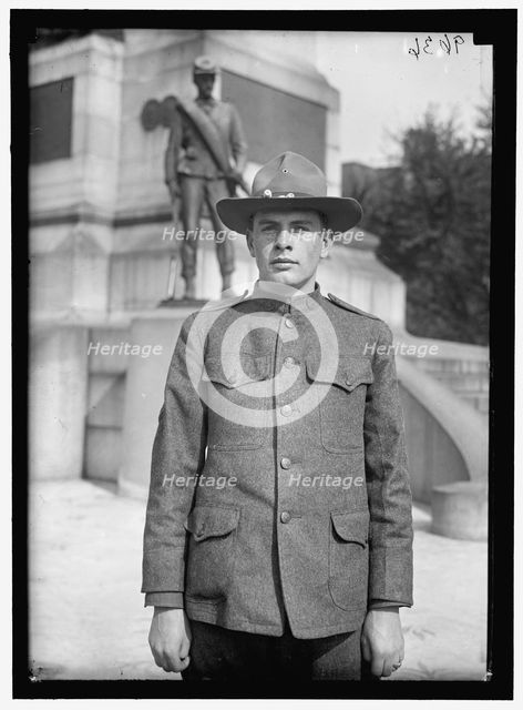 Young man in uniform standing in front of Sherman Monument, Washington, D.C., between 1916 and 1918. Creator: Harris & Ewing.