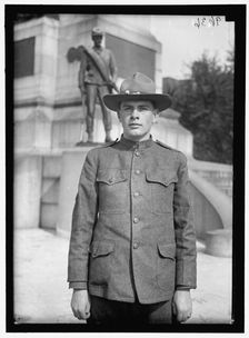 Young man in uniform standing in front of Sherman Monument, Washington, D.C., between 1916 and 1918. Creator: Harris & Ewing