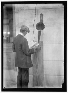 Young man standing near speaker, between 1910 and 1917. Creator: Harris & Ewing