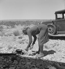 Young Negro wife cooking breakfast, outskirts of El Paso, Texas, 1938. Creator: Dorothea Lange