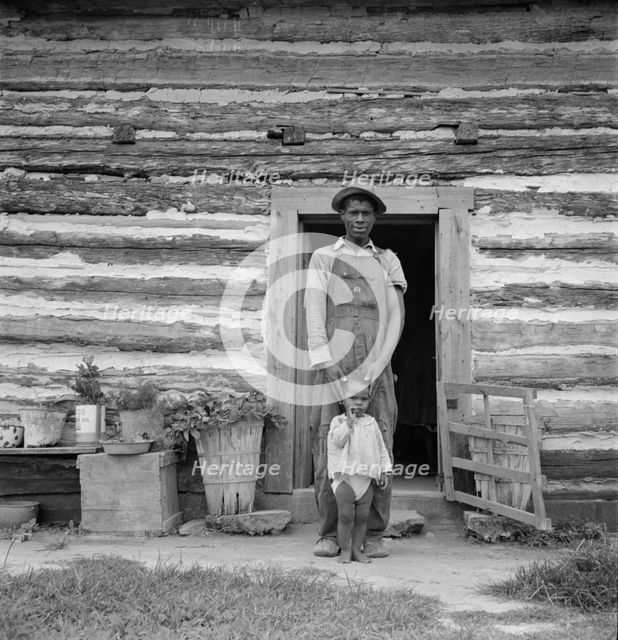 Young sharecropper and his first child, Hillside Farm, Person County, North Carolina, 1939. Creator: Dorothea Lange.