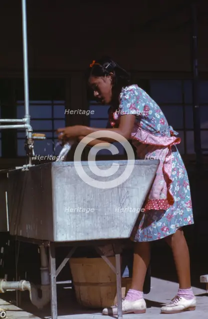 Young woman at the community laundry on Saturday afternoon, FSA ... camp, Robstown, Tex., 1942. Creator: Arthur Rothstein.