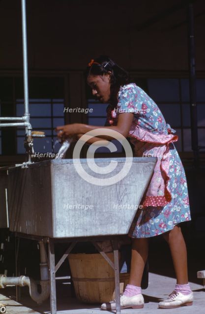 Young woman at the community laundry on Saturday afternoon, FSA ... camp, Robstown, Tex., 1942. Creator: Arthur Rothstein.