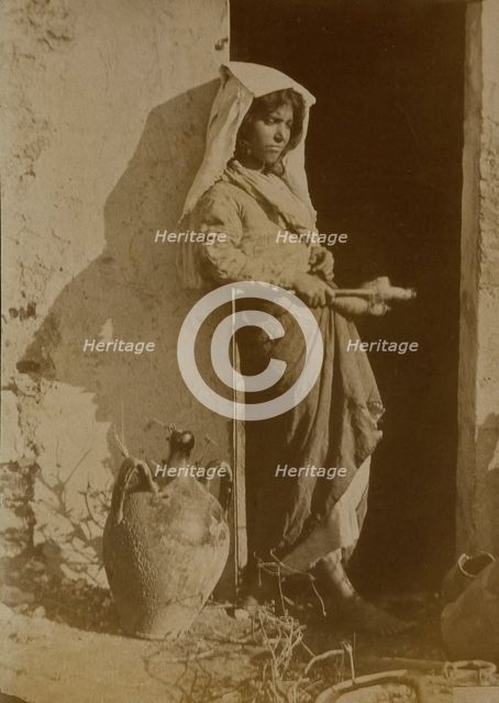 Young woman holding spindles, probably Taormina, Sicily, c1890s. Creator: Count Wilhelm von Gloeden.