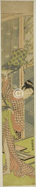 Young Woman Hanging a Painting, c. 1771. Creator: Isoda Koryusai.