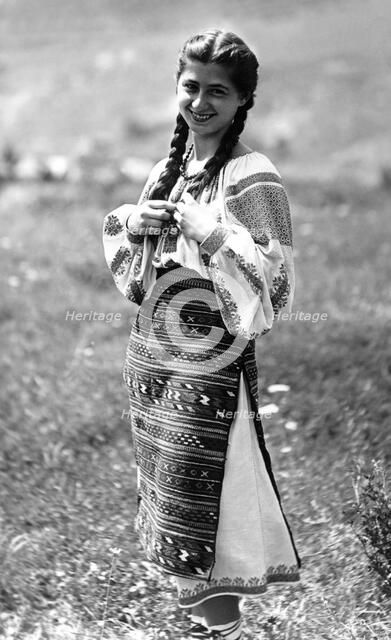 Young woman in traditional costume, Bistrita Valley, Moldavia, north-east Romania, c1920-c1945. Artist: Adolph Chevalier