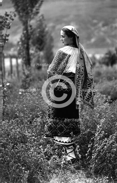 Young woman in traditional costume, Bistrita Valley, Moldavia, north-east Romania, c1920-c1945. Artist: Adolph Chevalier