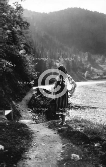 Young woman on a mountain footpath, Bistrita Valley, Moldavia, north-east Romania, c1920-c1945. Artist: Adolph Chevalier