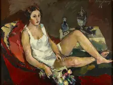 Young woman on red sofa, 1913. Creator: Anton Faistauer