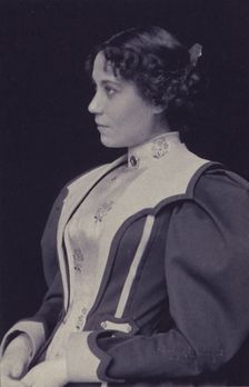 Young woman wearing high collared blouse and mutton-sleeved jacket, facing left..., c1900. Creator: Hollinger & Rockey