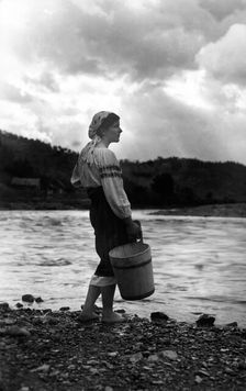 Young woman with a bucket, Bistrita Valley, Moldavia, north-east Romania, c1920-c1945. Artist: Adolph Chevalier