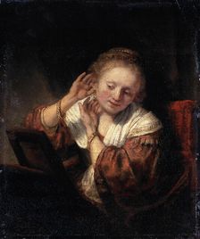 Young Woman trying on Earrings 1657. Artist: Rembrandt Harmensz van Rijn