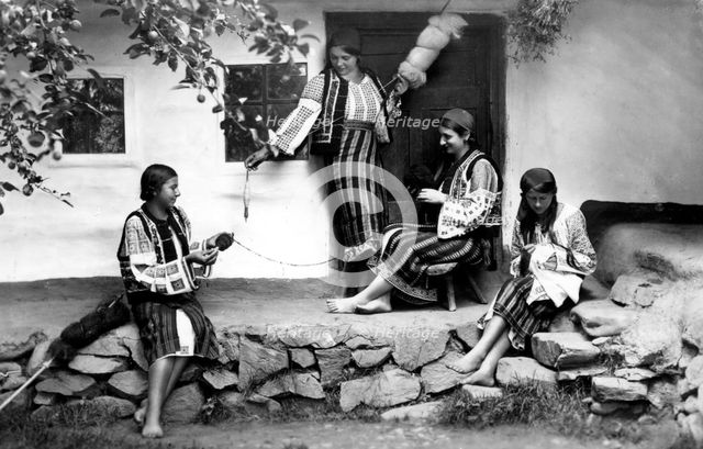 Young women spinning and sewing, Bistrita Valley, Moldavia, north-east Romania, c1920-c1945. Artist: Adolph Chevalier