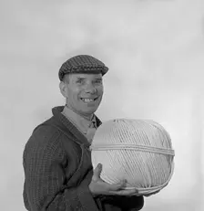 Yorkshireman wearing a flat cap and holding a large ball of twine, 1968. Creator: Michael Walters