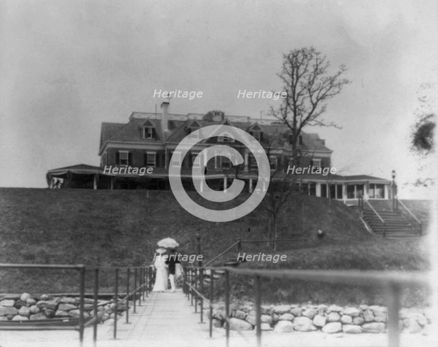 Yacht club, Oyster Bay, Long Island, N.Y. Couple walking on far end of bridge or pier, 1905. Creator: Frances Benjamin Johnston.
