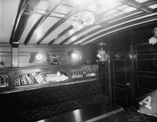 Yacht Althea, cabin, showing books, between 1907 and 1915. Creator: Unknown