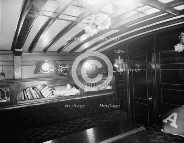 Yacht Althea, cabin, showing books, between 1907 and 1915. Creator: Unknown.