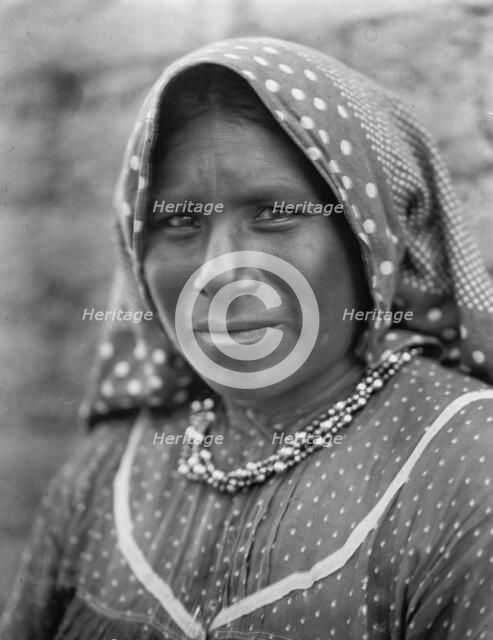 Yaqui matron, head-and-shoulders portrait, facing slightly left, wearing printed cotton..., c1907. Creator: Edward Sheriff Curtis.