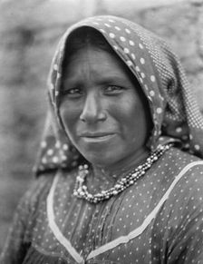Yaqui matron, head-and-shoulders portrait, facing slightly left, wearing printed cotton..., c1907. Creator: Edward Sheriff Curtis