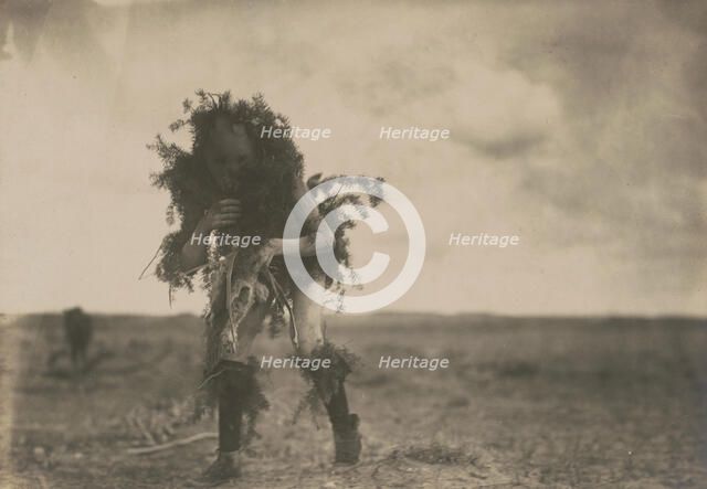 Yeibichai, the beggar, Tonenili-Navajo Indian, dressed in spruce branches, 1904, c1905. Creator: Edward Sheriff Curtis.