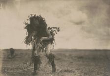 Yeibichai, the beggar, Tonenili-Navajo Indian, dressed in spruce branches, 1904, c1905. Creator: Edward Sheriff Curtis