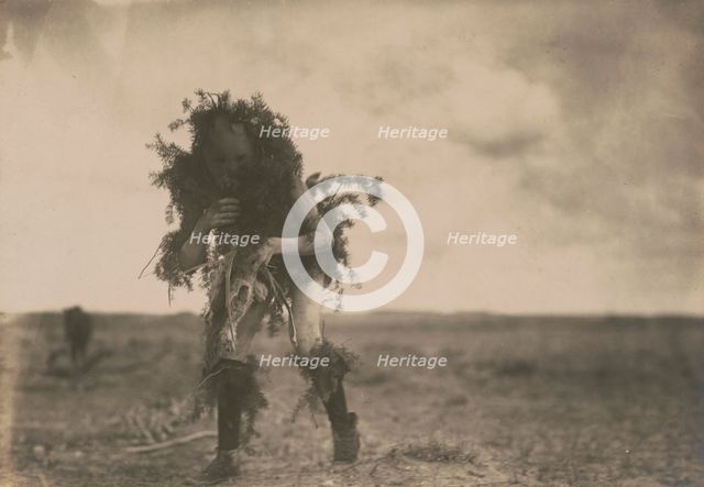 Yeibichai, the beggar, Tonenili-Navajo Indian, dressed in spruce branches, 1904, c1905. Creator: Edward Sheriff Curtis.