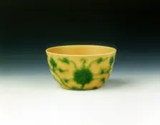 Yellow cup with lotus scrolls in green enamel, Yongzheng period, Qing dynasty, China, 1723-1735. Creator: Unknown