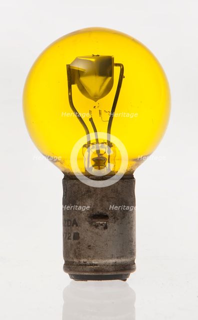 Yellow headlamp bulb. Creator: Unknown.