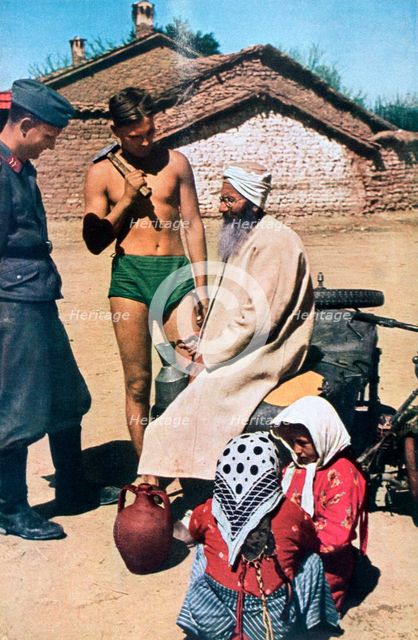 Yugoslavian pilots talking to a local, 1941. Artist: Unknown