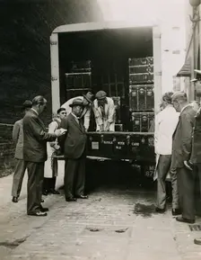 Zheng Tianxin (Dr Cheng) watching the unloading of cases in the West Yard at Burlington House, 1935. Creator: Topical Press Agency